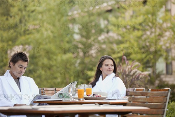 Couple enjoying breakfast on outdoor patio