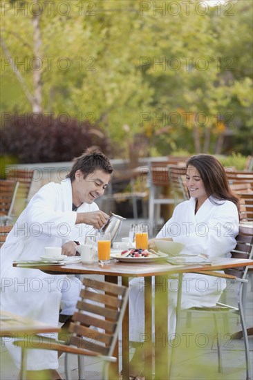 Couple enjoying breakfast on outdoor patio