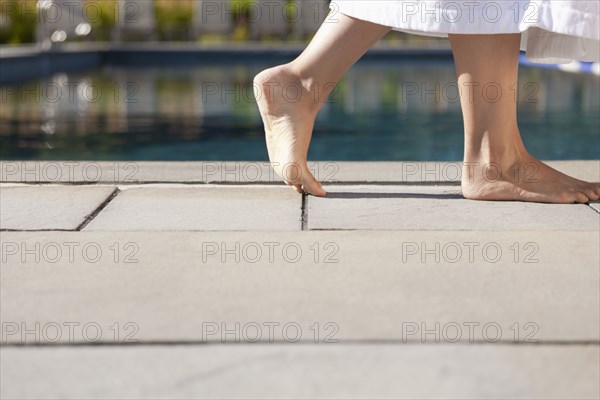 Woman walking near swimming pool