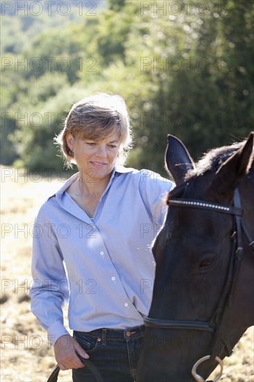 Caucasian woman watching horse