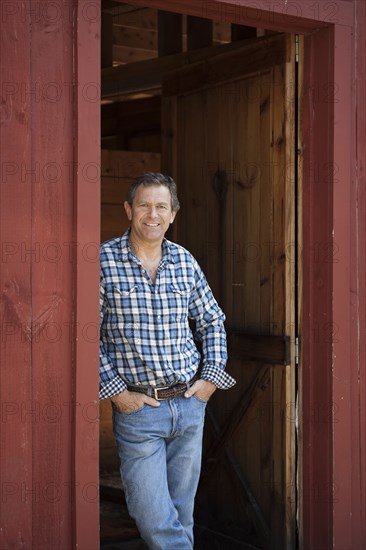 Caucasian man leaning in doorway