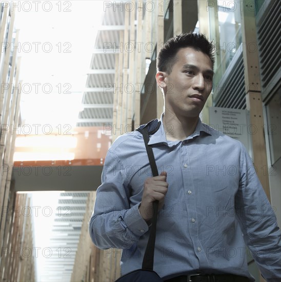 Chinese businessman walking on urban street