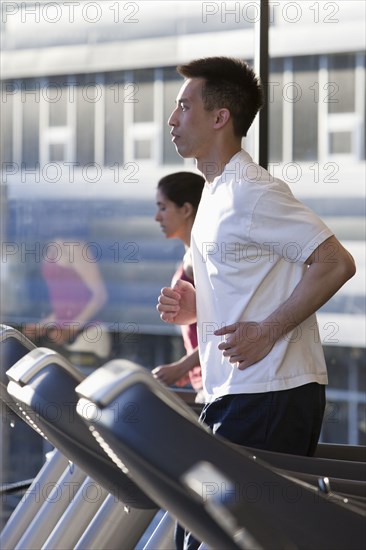 Man running on treadmill in health club