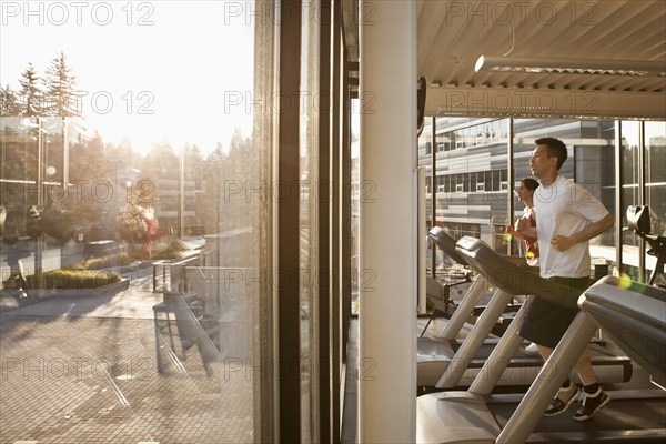 Man running on treadmill in health club