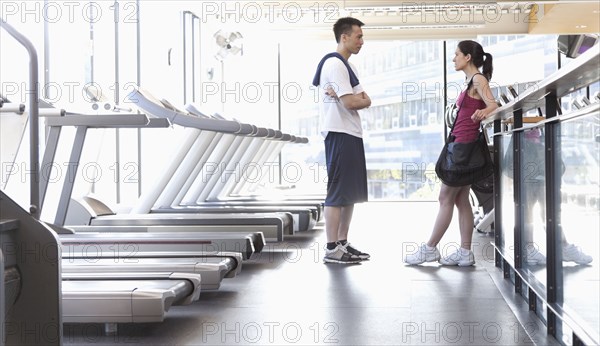Couple talking together in health club