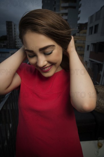 Caucasian woman smiling on balcony