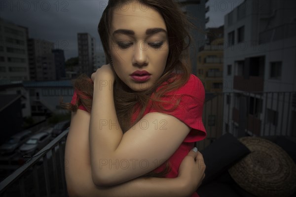 Caucasian woman standing on balcony