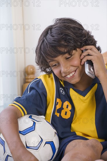 Mixed Race boy talking on cell phone