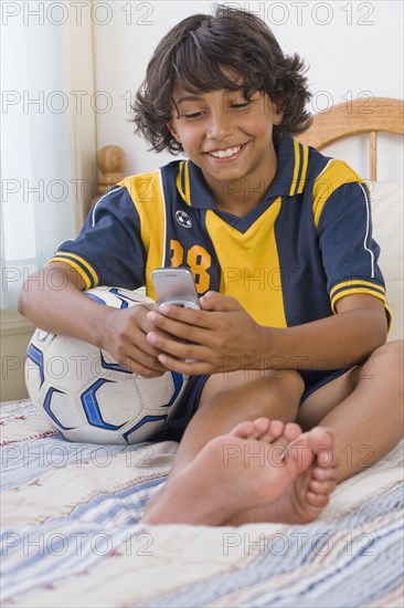 Mixed Race boy dialing cell phone