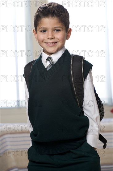 Hispanic boy with hands in pockets