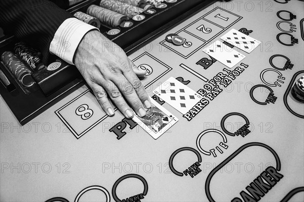 Hand of dealer at baccarat table