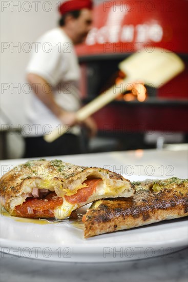 Pizza slices on plate in pizzeria