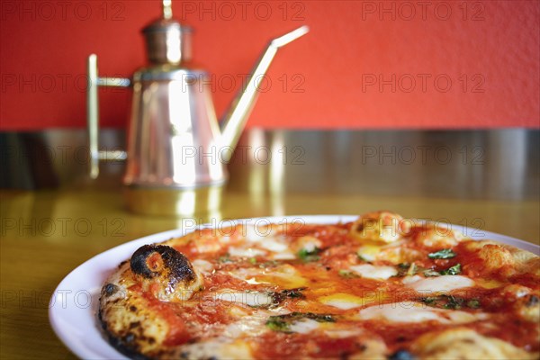 Pizza on plate in pizzeria