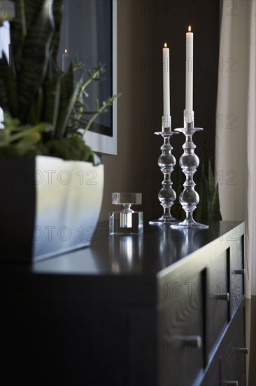 Contemporary dresser with candlesticks and house plant