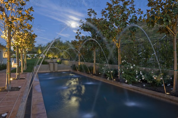 Crossing fountains across swimming pool