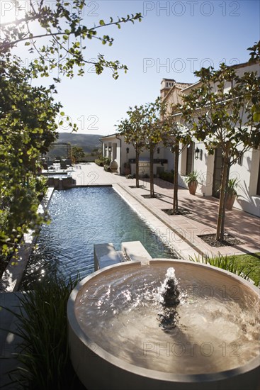 Backyard with fountain leading into swimming pool