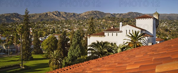 Detail red tile roof and view of houses on mountainside