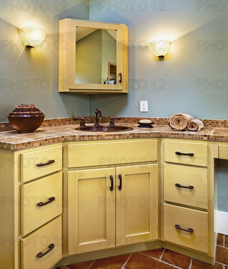 Sink and cabinets in corner of bathroom