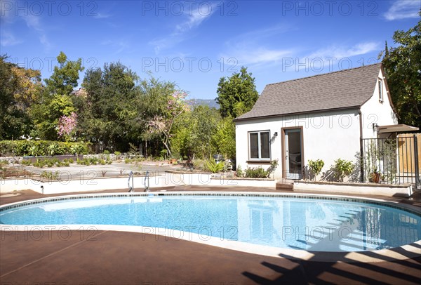 Inground pool in cottage backyard