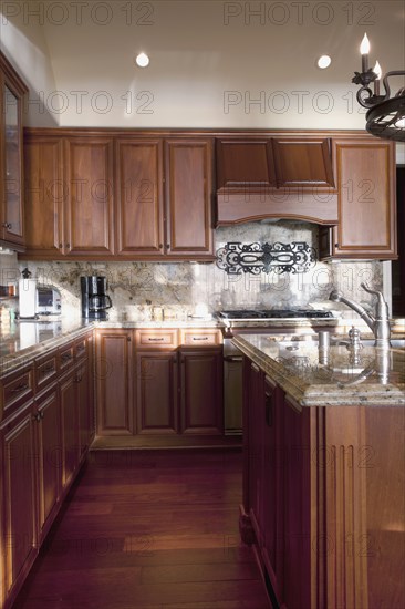 Hardwood floors and wooden cabinets in traditional kitchen