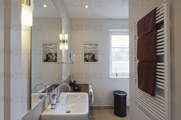 Towel warmer and sink in domestic bathroom