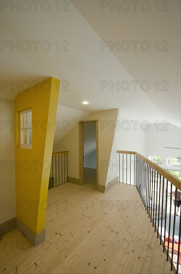 Empty wooden hall with doorway and railing at home