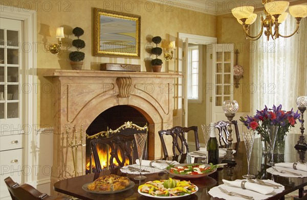 Traditional dining room with fireplace and several place settings