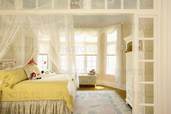 Girls bedroom with bay window and mosquito netting
