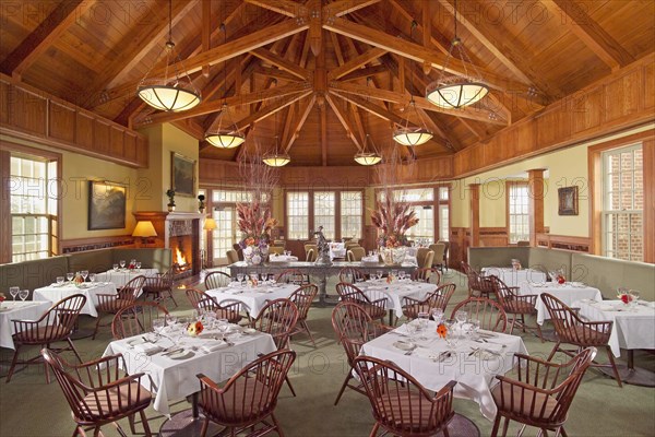 Grand dining room with several tables and wooden ceilings