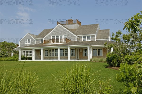 Exterior contemporary shingle style home with rooftop balcony