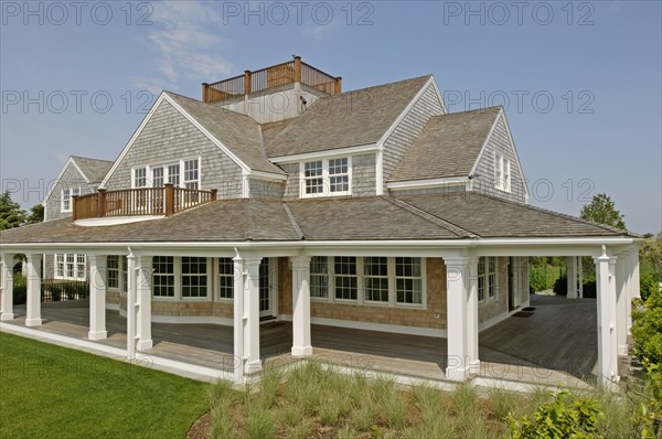 Exterior contemporary shingle style home with rooftop balcony