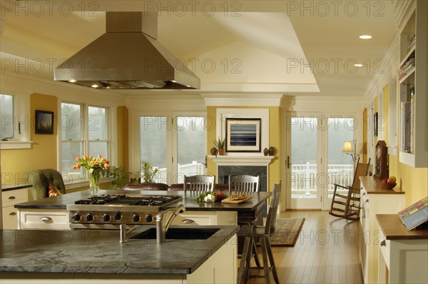 Contemporary kitchen with granite countertops and a stainless steel range vent