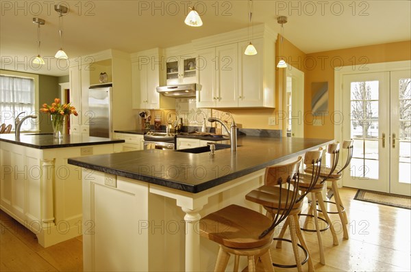 Simple contemporary kitchen with island and breakfast bar