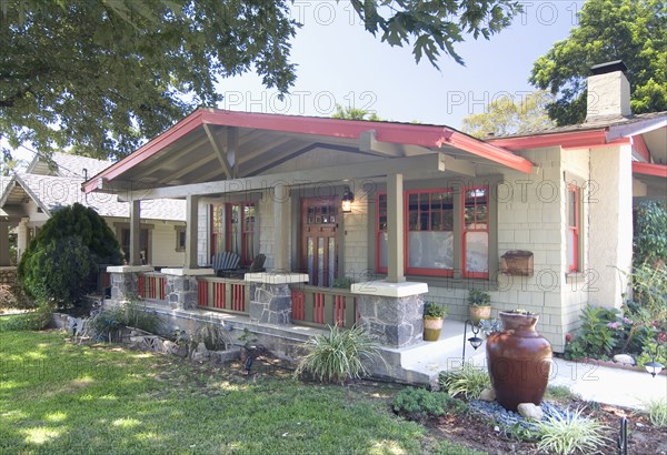 Exterior one story bungalow with red trim