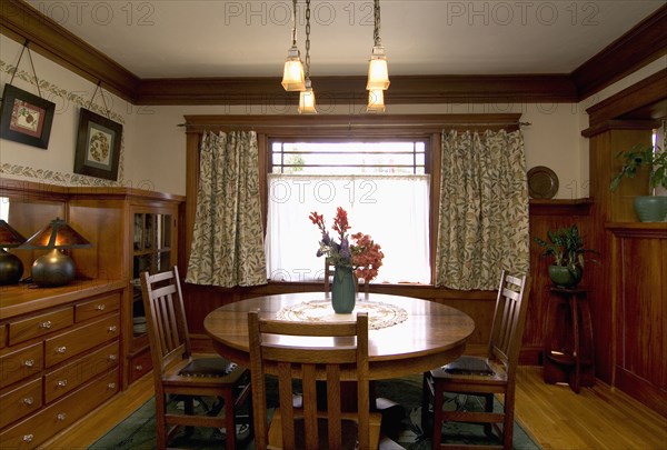 Vase filled with flowers on a dining room table