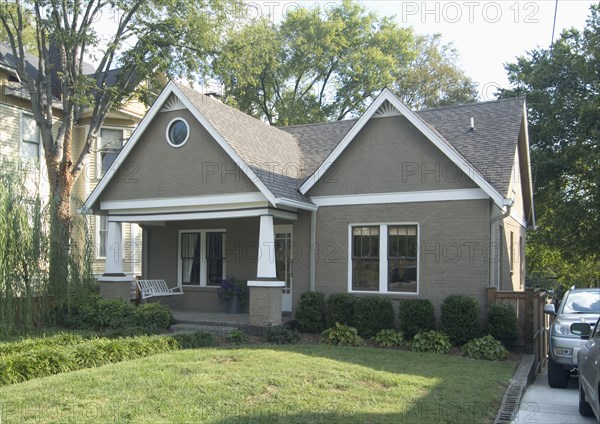 Front exterior of a one story bungalow with white trim at Nashville