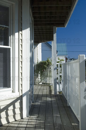 Railing shadows on wooden front porch