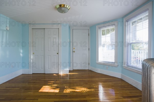 Empty room in apartment with hardwood floor and heater