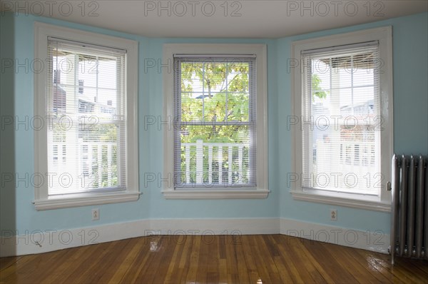 Empty room in apartment with hardwood floor and heater