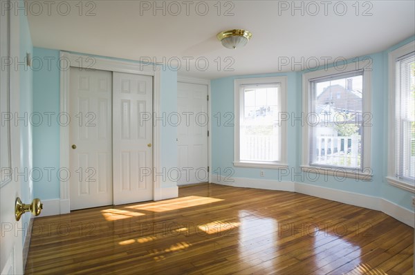 Empty room in apartment with hardwood floor