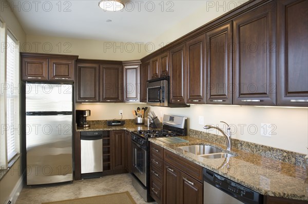 Contemporary kitchen with dark colored cabinets