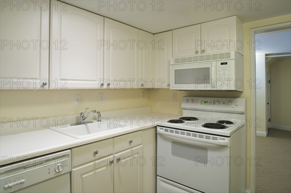 White stove and kitchen in empty apartment