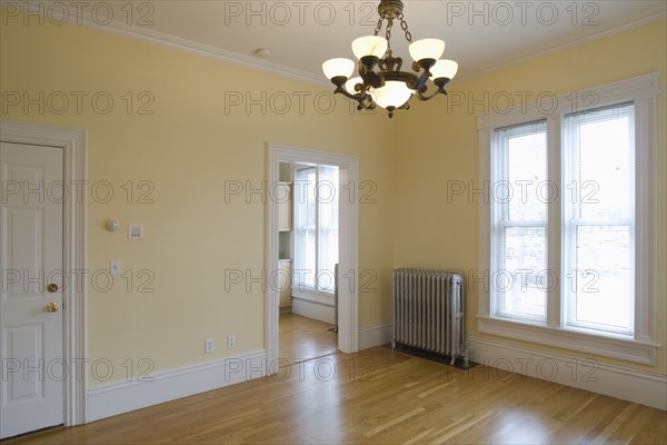 Empty room in apartment with hardwood floor and heater