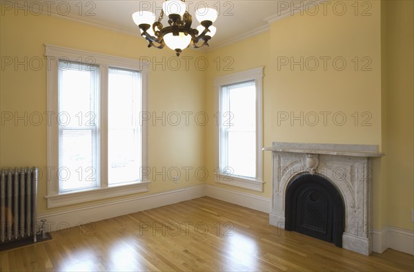 Empty room in apartment with hardwood floor and heater