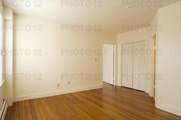 Empty room in apartment with hardwood floor