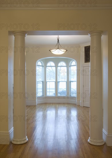 Empty room in apartment with hardwood floor and bay window