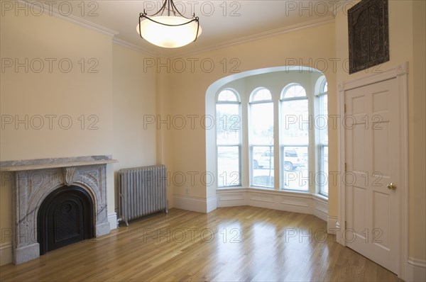 Empty room in apartment with hardwood floor and bay window