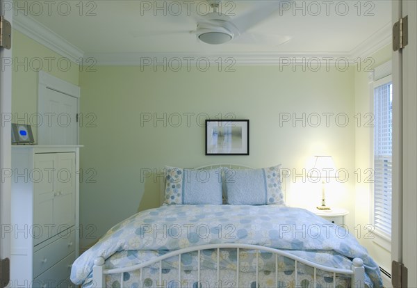 Blue and yellow bedspread on bed