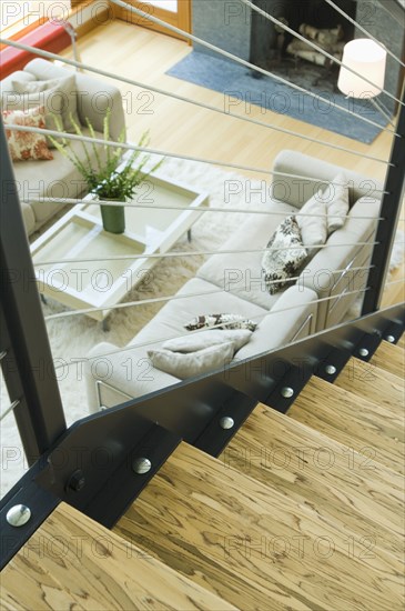 Detail top of wooden staircase overlooking living room