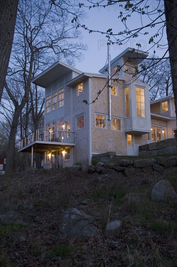 Contemporary shingle style home at dusk